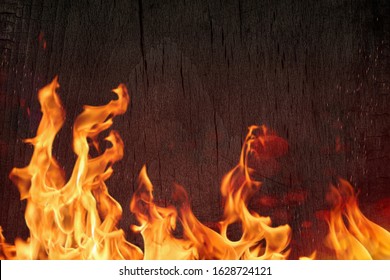 Burning black Board with  open red fire flame. Burned scratched hardwood surface. Smoking wood plank bbq background.