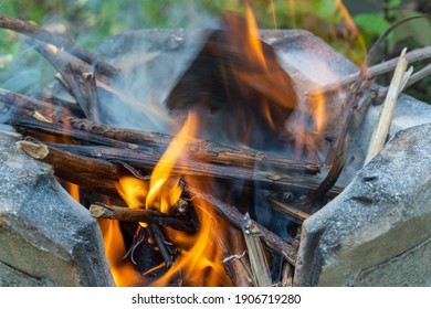 Burning Black Charcoal In The Old Stove With Paper And Dry Wood. It Produces A Lot Of Smoke When It Burns.