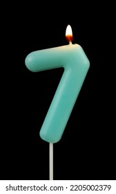 Burning Blue Birthday Candle Isolated On Black Background, Number 7