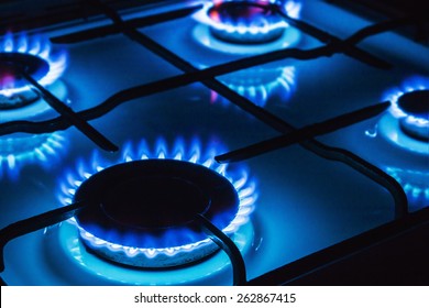 Burning blue gas. Focus on the front edge of the gas burners