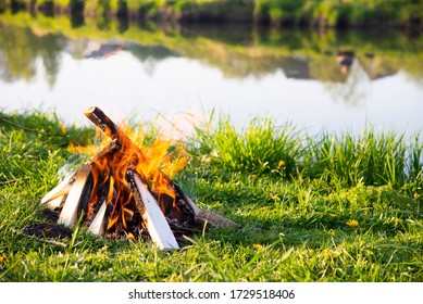 Burning Bonfire By The River In The Summer