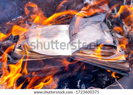 Burning book. The book is on fire. Burning unnecessary books