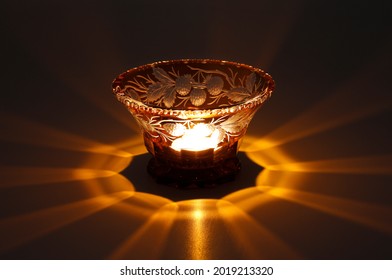 Burning Candle In A Cut Glass Bowl, Black Background