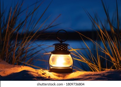 Burning Candle Lantern On The Beach. Sea And Night Sky On Background. Candle Light. 