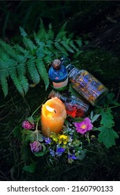 Burning Candle, Magic Witch Bottles, Flowers On Dark Forest Natural Background. Magic Ritual, Witchcraft, Spiritual Practice. Pagan, Wiccan, Slavic Traditions. Esoteric Ritual For Midsummer, Litha