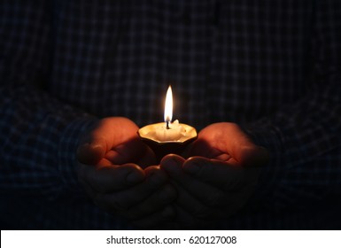 Burning Candle In A Mans Hand Religion Concept