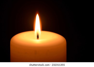 Burning Candle On A Black Background  