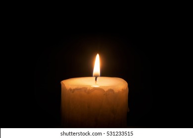 Burning Candle On A Black Background