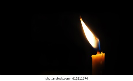 Burning Candle On A Black Background