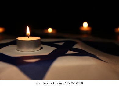 Burning Candle On Flag Of Israel. Holocaust Memory Day