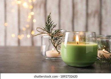 Burning Candle With Pinecone Scent On Black Table, Space For Text