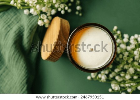 Burning candle in spring interior.