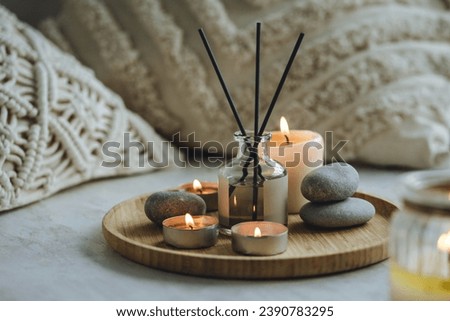 Burning candles, aroma fragrance natural organic diffuser, wooden bamboo tray. Concept of cozy home space for meditation, relaxation, detention. Spiritual aura cleansing routine for full moon ritual Stock fotó © 