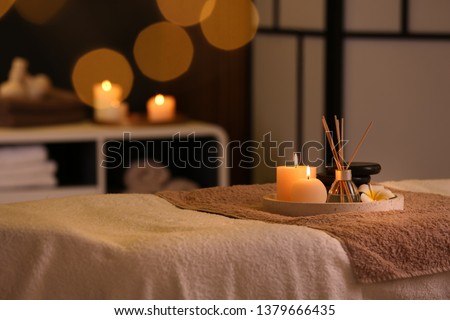 Burning candles and aromatic reed freshener on table in spa salon, space for text Zdjęcia stock © 