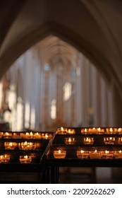 Burning candles in catholic church in the evening candle fire - Shutterstock ID 2209262629