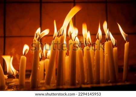 Similar – Many lighted candles in a church