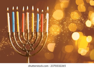 Burning candles for Hannukah celebration on brown background with space for text