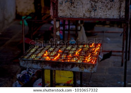 Burning candles inside of a metallic tray inside temple. Kathmandu, Nepal, Asia