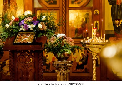 burning candles on the background of icons in the Orthodox Church. Soft focus, selective focus