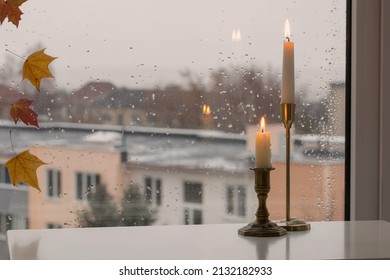 Burning Candles On Background Rainy Window Pane