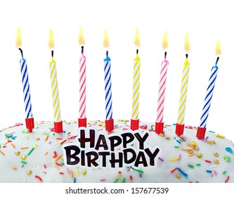 burning candles on a birthday cake on a white background