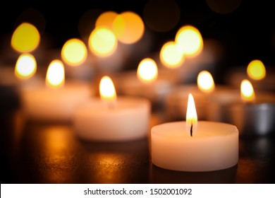 Burning Candles On Table, Closeup. Funeral Symbol