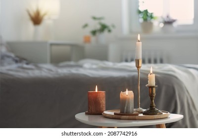 Burning Candles On  White Table In Bedroom