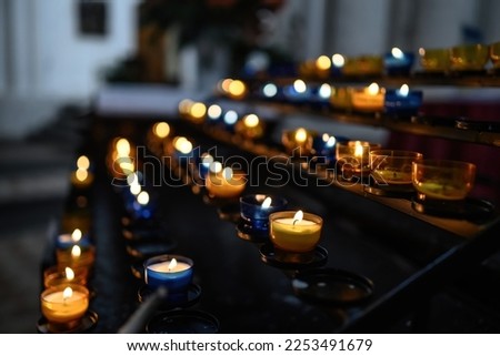 Burning candles in transparent chandeliers inside cathedral church. Traditional christian worship.