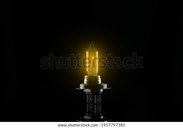 burning car lamp on a dark
background