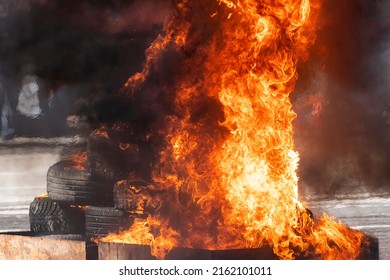 Burning car tires as a protest and a riot in the city. City riots. A strong flame from gorenje rubber. - Shutterstock ID 2162101011