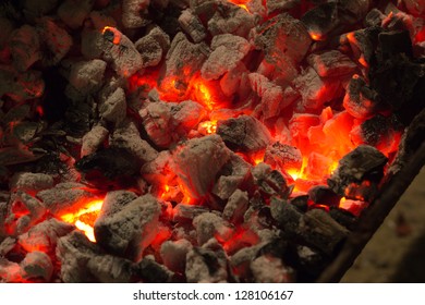 burning charcoal in the background