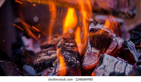 burning charcoal, fire, sparks and hall in a bonfire