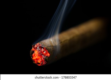 Burning Cigar On Black Background