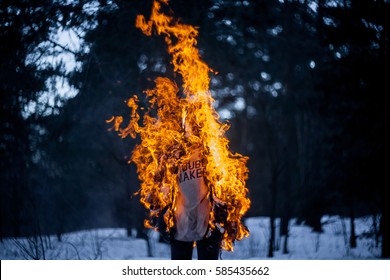 Burning clothing per person. A burning silhouette of a man. Image of a man on fire. Man on Fire. stuntman working on the fire. surrealism theme. Close-up portrait of a burning man.