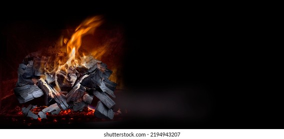 Burning Coal In A Barbecue Pit - On Black Background With Copy Space