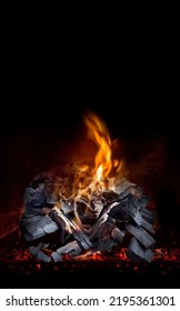 Burning Coal In A Barbecue Pit - On Black Background With Copy Space