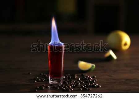 Burning cocktails with lime and coffee beans on a table