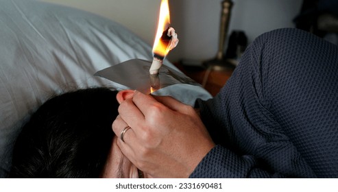 Burning cone ear wax removal ear candling - Powered by Shutterstock