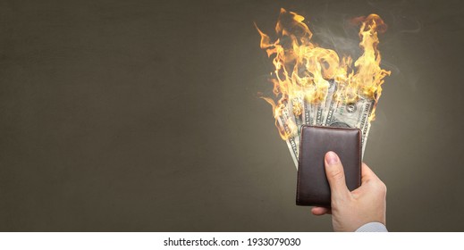 Burning Dollar banknotes inside a wallet with copy space