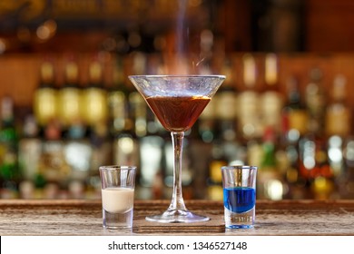 A burning drink on the bar. Cocktail for a youth party. 