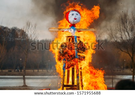 Burning Effigies Straw Maslenitsa In Fire On Traditional National Holiday Dedicated To  Approach Of Spring - Slavic Celebration Shrovetide.