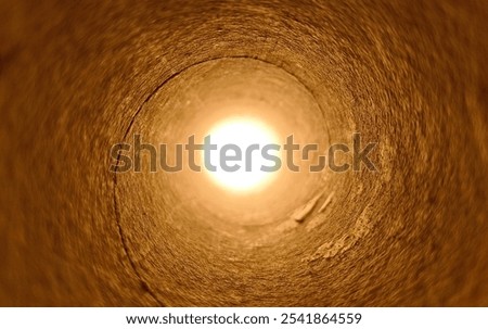 Burning fire flame light deep inside petrochemical natural gas, fuel or oil distribution or transfer plant round pipe hole coming out. Underground pipeline, mine, rig, well or tunnel explosion concept
