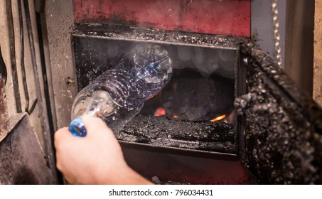 Burning Garbage In A Coal Furnace, Plastic Bottle. Problems With Smog.