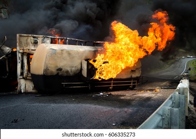 Burning gas flame tank truck road accident on the track selective focus