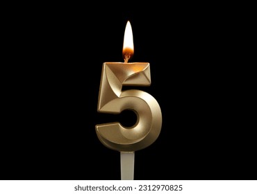 Burning gold birthday candle isolated on black background. Number 5.