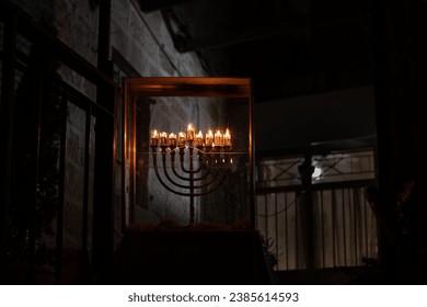 Burning Hanukkah candles cast a glow on the cobblestone streets of the Old City of Jerusalem on the eighth night of the Festival of Lights in Israel. 