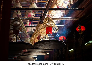 Burning Incenses In A Man Mo Temple In Hong Kong