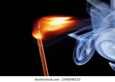 Burning matchstick with vibrant flame and smoke trails against a dark background, close-up view, dynamic motion, abstract composition, vivid light contrast - Powered by Shutterstock