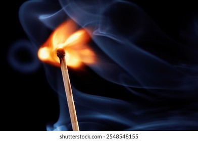 Burning matchstick with vibrant flame and smoke trails against a dark background, close-up view, dynamic motion, abstract composition, vivid light contrast - Powered by Shutterstock