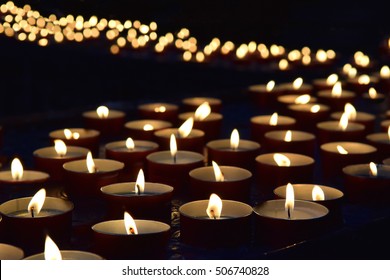 burning memorial candles on the dark background
